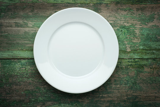Empty  white plate on wooden background