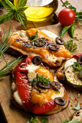 Buschetta with grilled bell pepper, mozzarella cheese and herbs