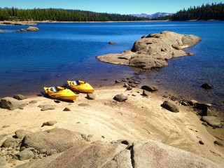 Kayaks resting on beautiful Lake shore.