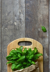 Bunch of basil in a paper bag.Copyspace background.