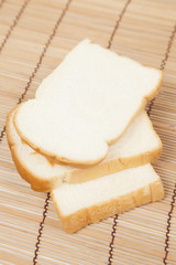 Sliced ​​bread on the wooden plate.