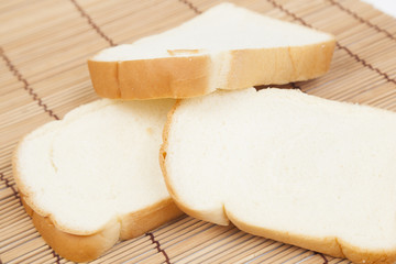 Sliced ​​bread on the wooden plate.