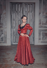 Beautiful woman in red long medieval dress