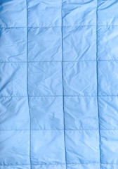 Closeup of blue silk quilted fabric as a background