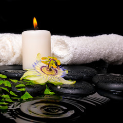 Obraz na płótnie Canvas spa setting of passiflora flower, green branch fern, towels and