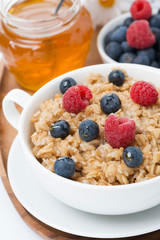oat porridge with berries and honey, top view