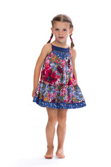 Little girl in a colorful dress in the studio.