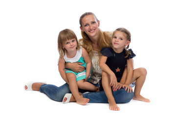 Family portrait of a young charming mother and two daughters.