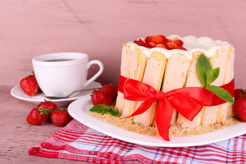 Tasty cake Charlotte with fresh strawberries on wooden table