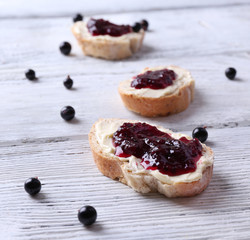Fresh bread with homemade butter and blackcurrant jam