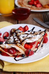 Delicious pancakes with berries on table close-up