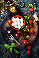 Cherry tomatoes, basil leaves, mozzarella cheese and olive oil f