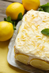 Tasty lemon cake on table at home