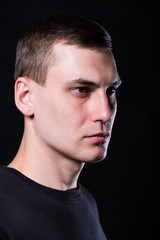 Fototapeta premium Young man on black