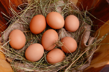 Eggs in wooden basket on table close-up