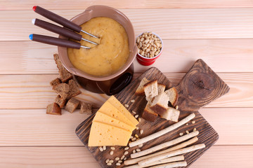 Fondue, biscuits, slices of cheese and rusks