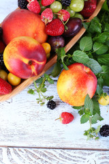 Different berries and fruits on wooden table close-up