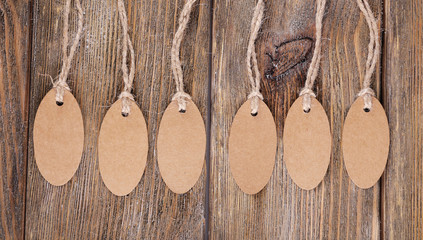 Brown tags on wooden background