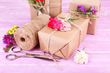 Fototapeta na wymiar Beautiful gifts with flowers and decorative rope,