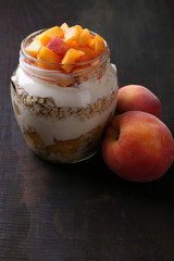 Healthy breakfast - yogurt with  fresh peach and muesli served