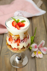 Natural yogurt with fresh berries on wooden table