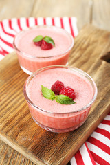 Delicious berry mousse in bowls on table close-up