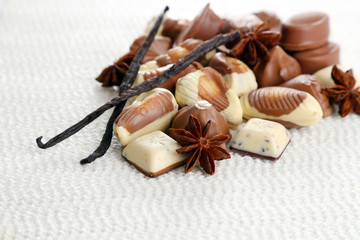 Fototapeta na wymiar Different kinds of chocolates with spices on white background