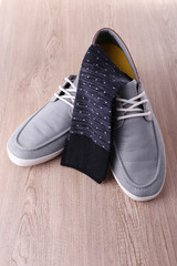 Top-siders and socks on wooden background