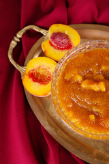tasty apricot jam with fresh apricots on metal tray
