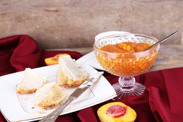 tasty bun with homemade jam on wooden table