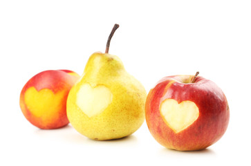 Ripe fruits with hearts isolated on white