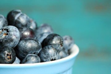 Tasty ripe blueberries, on wooden background