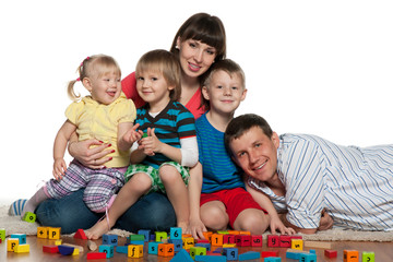 Family with children play the floor