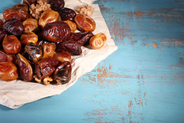 Tasty dates fruits on blue wooden table