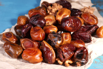 Tasty dates fruits on blue wooden table