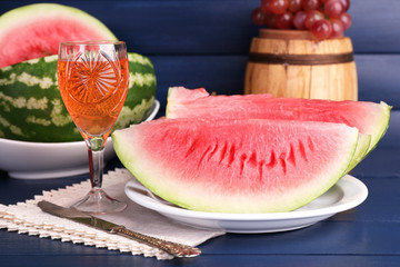 Composition of ripe watermelon, fruits, pink wine in glass and