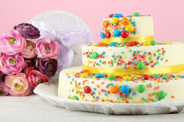 Beautiful tasty birthday cake and gifts on color background