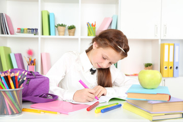 Fototapeta premium Cute girl at workplace in classroom