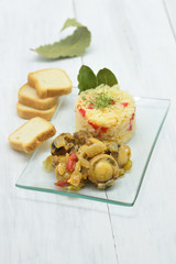 small scallops cooked with white rice and bay leaves