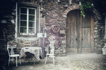Fototapeta na wymiar Old farm backyard with table and chairs