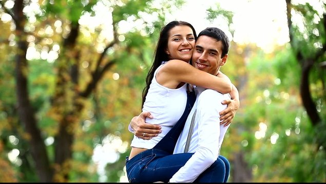 Couple hugging in the park.