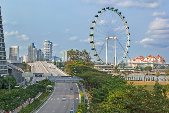 Ferris weel and highroad in moderm cityscape, Singapore