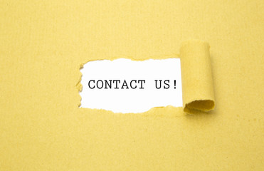 Contact us! written white background with torn brown paper