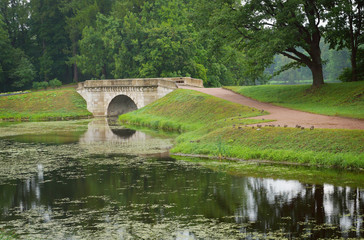 Fototapeta na wymiar Landscape with old bridge in Gatchina