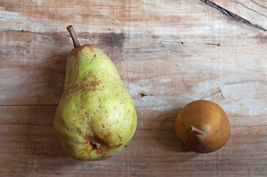 Two pears in old wooden background