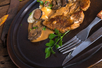 Steak with potato dumplings and forest mushroom sauce