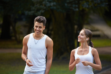 Sport couple walking in the summer park