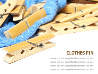Wooden clothes pin and laundered denim fabric isolated on white