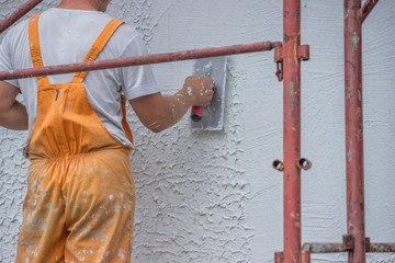 Plasterer applying a finish coating to a wall