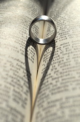Ring casting a heart-shaped shadow in a book